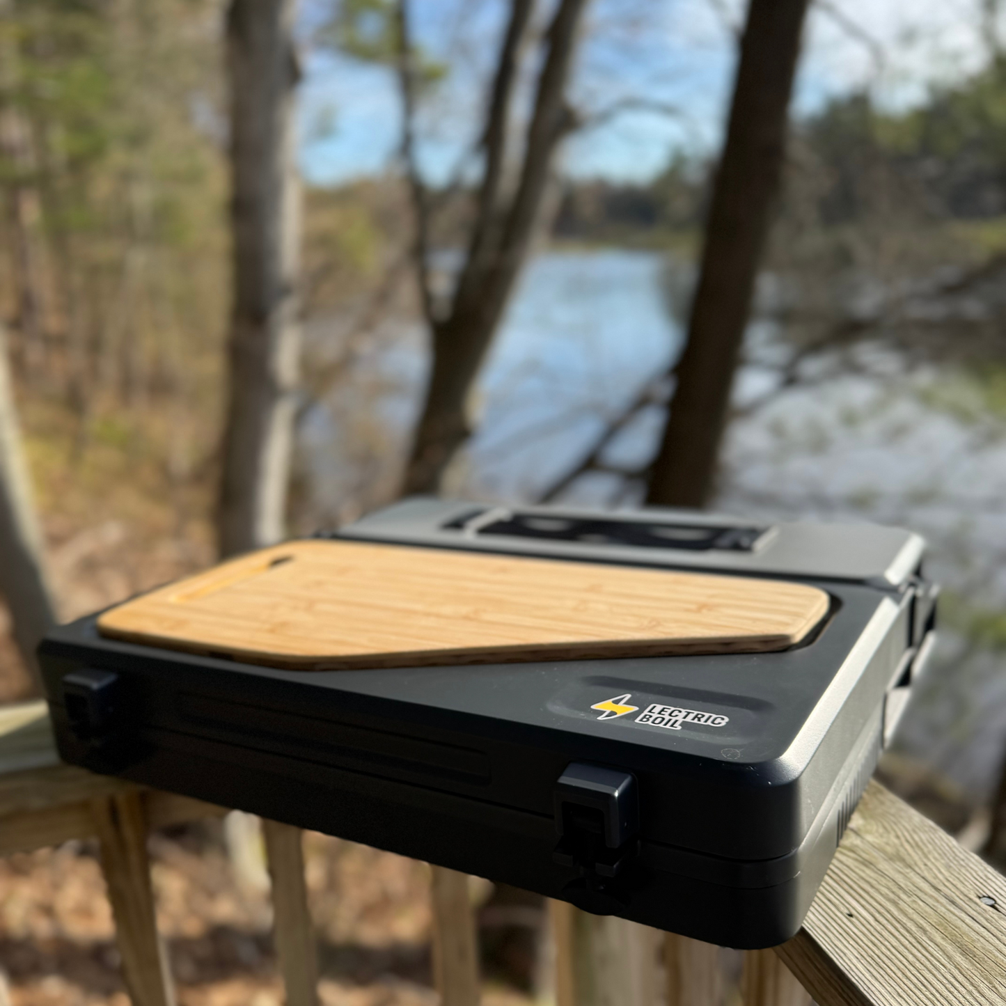 The Lectric Boil , pictured here closed, no plugs needed, solar plug in, patent pending prototype with removable battery generator to recharge your essentials off-grid and removable cutting board. Made in the USA with induction technology. For camping, sustainable camping, glamping,overlanding, off grid living.