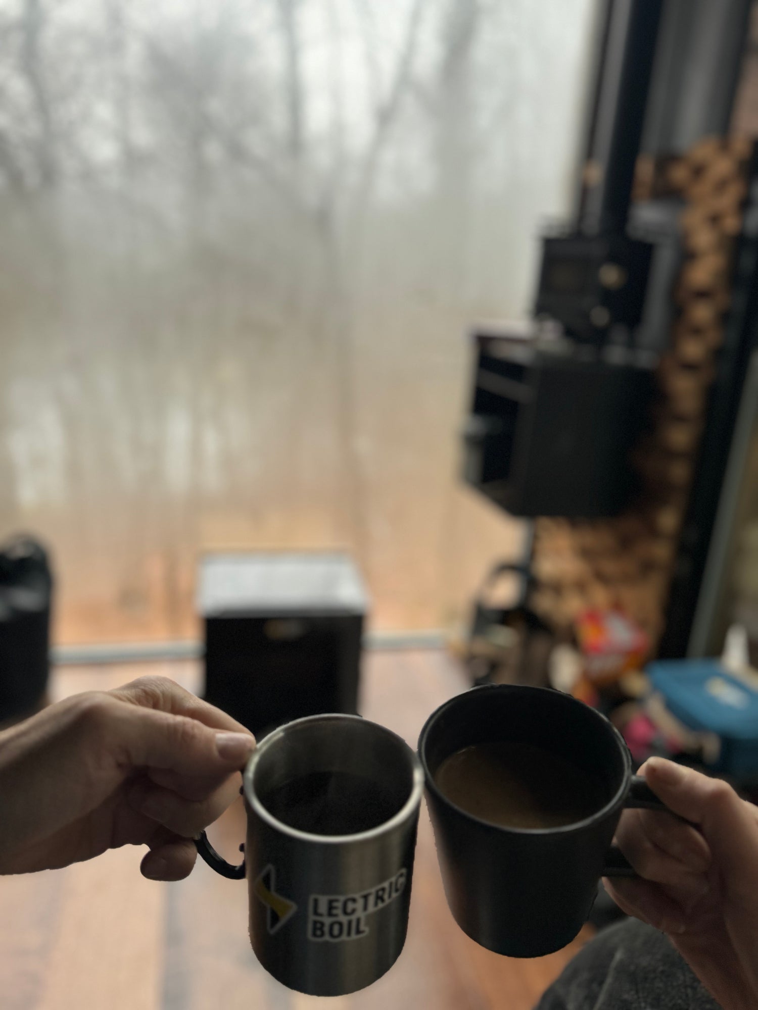 Two mugs, one Lectric Boil branded, touching. The first portable induction stove and generator with a battery and dual burners for campers, outdoor workers, natural disasters — and anyone, anywhere, cooking or surviving off-grid.